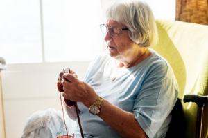 senior hospice patient knitting at home